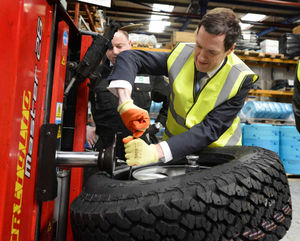 George Osborne works on a tyre