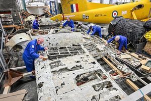RAF Museum volunteers with the Dornier wing section.