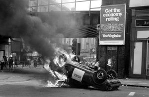 A police car blazes at the corner of Atlantic Road and Brixton Road, Brixton