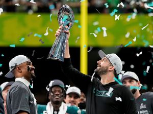 Philadelphia Eagles head coach Nick Sirianni, right, lifts the Vince Lombardi Trophy next to quarterback Jalen Hurts