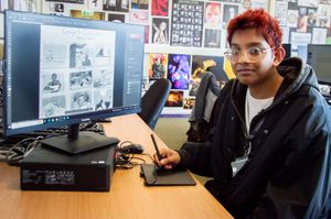 Art student Shafi Rahman working on his illustrations for the new children's book