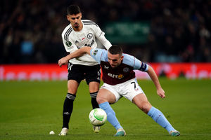 Aston Villa's John McGinn and Legia Warsaw's Gil Dias battle for the ball during the UEFA Europa Conference League