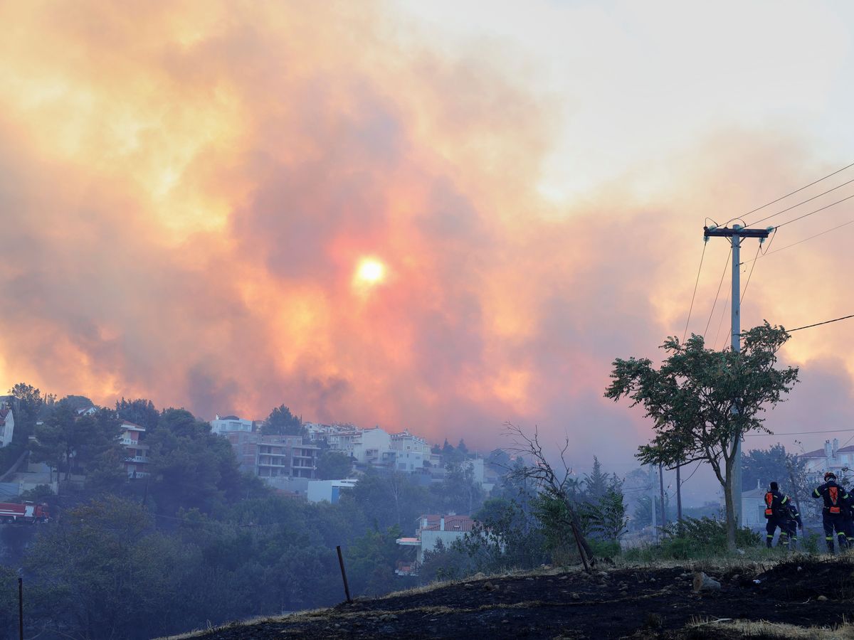 Wildfire burns through Athens suburb as residents told to evacuate