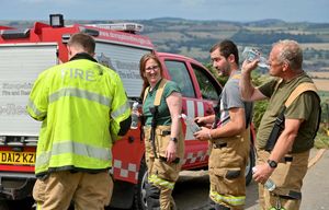 Damping down of a fire on grassland near Minsterley