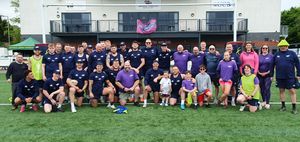 Players, staff and volunteers pose together following the event