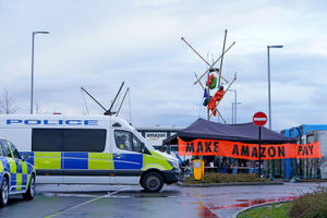 Activists from Extinction Rebellion block the entrance to the Amazon fulfilment centre in Coventry