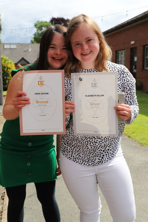 Derwen College's Lizzie and Zara with their awards