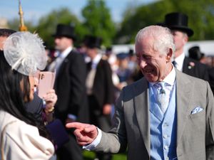 Supporting image for story: Charles appears in good spirits with guests at Buckingham Palace garden party