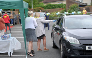 Pupils could drive around the playground with family members in cars, pose for pictures, collect goodie bags and receive a medal
