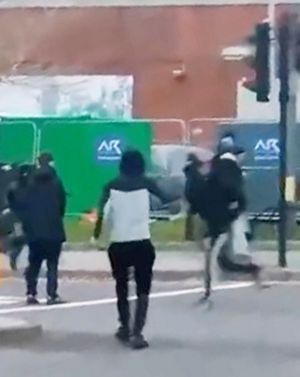 Footage shows the youths running through roads towards each other.