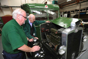 Alan Bishop and Tony Land look at the engine of the recently restored ambulance.