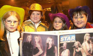 Atomic Kitten fans Emily Buttery, 9, Becky Buttery, 10, Jemma Harborne, 10, from Dawley, and Letitia Dean, 10, from Shrewsbury, have a look at the Shropshire Star before the show at Telford Ice Rink in November 2001.