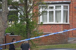 Two bullet holes could be seen in the windows of the address