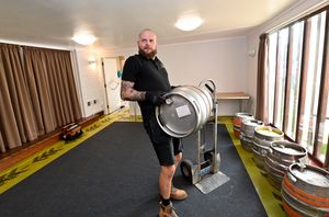 Luke Small moves the barrels into place in the hall