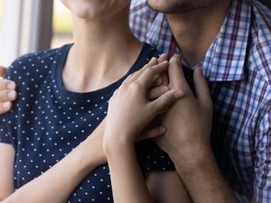 Close-up shot of a young couple hugging