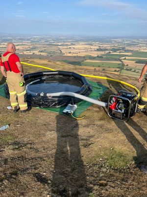 Firefighters set up equipment at the top of the Wrekin to deal with the incident. Picture: Amber Watch Wellington