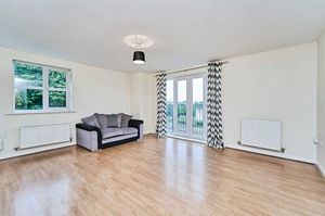 The lounge is spacious, with modern laminate flooring