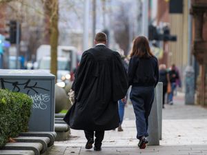 A barrister outside the Crown Court at Laganside in Belfast as the start of a month long withdrawal of services in legal aid funded cases in the Crown Court in an ongoing dispute over fees