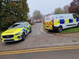 Police in Corporation Street, Stafford, after a woman was arrested on suspicion of murder following the deaths of two children