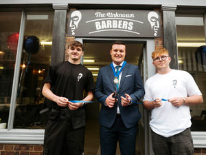 Harry Bushell with Deputy Mayor of Much Wenlock Dan Thomas and co-barber Charlie Griffiths at their shop opening in July 2024