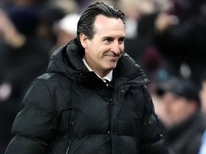 Unai Emery smiles on the touchline