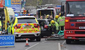 Paramedics and firefighters attend the scene of the collision