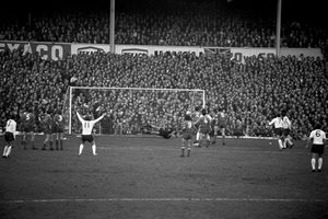 Derby County's Alan Hinton (fifth l) celebrates prematurely as Juventus goalkeeper Dino Zoff (c, diving) pushes his shot around the post.