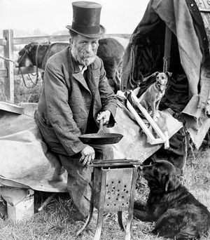 August 1962 - Fred Abel, of 'the smallest show on Earth.' The caption said: 'Ringmaster and proprietor, Fred Abel, is seen preparing breakfast near Penkridge, surrounded by the principal 'actors' in his one man circus, the donkey, the border terrier, and the star of the show 'Towser, the wonder dog.' Fred, who advertises on the side of his caravan 'the smallest show on earth' has had, he says, 'a shocking season, the worst since the show went 'on tour' 13 years ago.' 