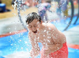 Danny Ebanks, aged 11, from West Bromwich, cools off in the play area at Walsall Arboretum..