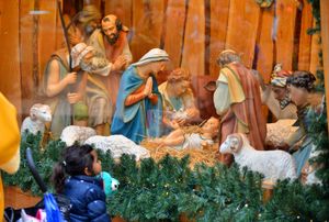This girl takes a closer look at the nativity scene which is a long-standing feature of the Christmas market 