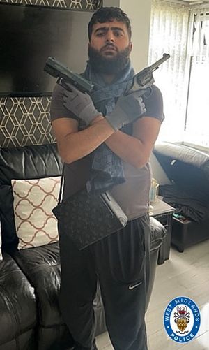 An image of Amjad holding the guns was discovered on his phone