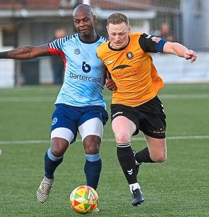 Former professionals Leroy Lita and Sam Mantom battle for the ball