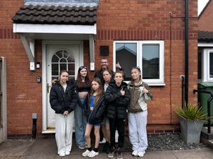 The Deeming-Thomas family outside their modest home in Stafford