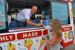 Karl Simcock serves Louisa and Theo Evans on a humid and hot day at Queens Retail Park