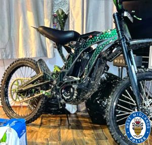 The bike is described as a black and green Surron Lightbee electric bike