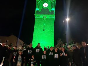 Supporting image for story: Wednesbury's historic clock tower turned dinosaur green for brave boy battling cancer