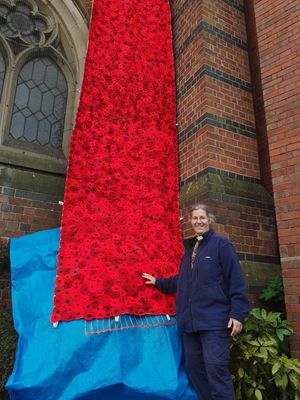 Rev Katryn Leclezio with the poppy cascade at St Peter's Church. 