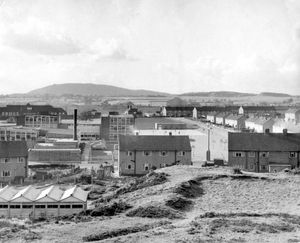 A view of Dawley, October 1960. The houses in the foreground are in Manor Road, Dawley, and just beyond is what was then Dawley Secondary Modern School, which in 1965 became Phoenix School, a comprehensive. Centre left in distance is the Georgian-style Pool Hill Junior School, which burnt down circa July 1977. The very large building in the far distance, centre, is Horsehay Works aka the Horsehay Company, (later Adamson Alliance, AB Cranes, Adamson Butterley). On right is Webb Crescent, Dawley.