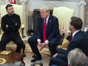 JD Vance, right, speaking to Volodymyr Zelenskyy, left, as Donald Trump listens in the Oval Office