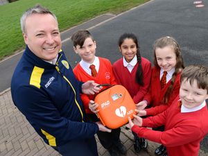 Supporting image for story: Football club helps school net lifesaving equipment