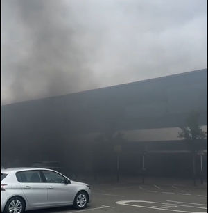 Fire alarms could be heard blaring from the building as the smoke towered above