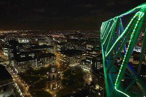 View of the lit crane jib and Birmingham city at night