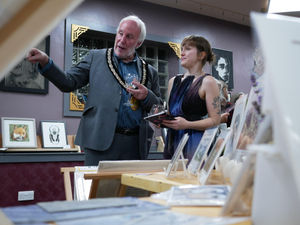 The Mayor of Kington Councillor Philip Sell and Vicki Larratt from the Old Picture House in Kington admiring the exhibits at the private view. Image by Andy Compton