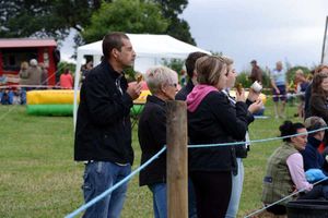 Spectators watch the horses in competition at the show.