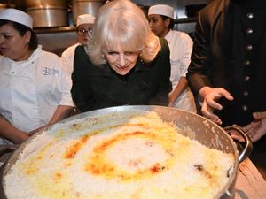 The Queen looks at a pot of basmati rice