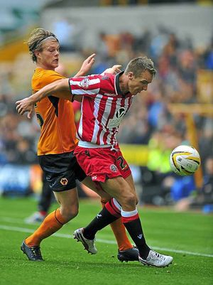 Sheffield United's Anthony McMahon (right) holds off Wolverhampton Wanderers' Bjorn Sigurdarson