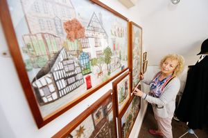 Volunteer Helen Sweet admiring the Charter Embroidery by Group 94