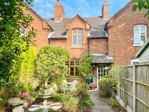 The cottage is in the centre of a row of three and has accompanying grounds that are very impressive. Photo: Yopa