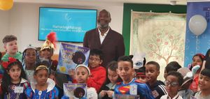 Sir Lenny Henry poses with pupils from different schools who had attended the Reading for Smiles Children’s Book Festival at the Midlands Arts Centre