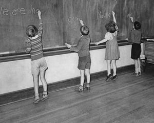Four young children writing on the classroom blackboard circa 1950. (Photo by Keystone View/FPG/Getty Images)